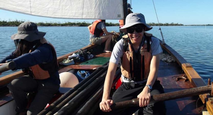 a group of students sit in a sailboat on an outward bound course in florida